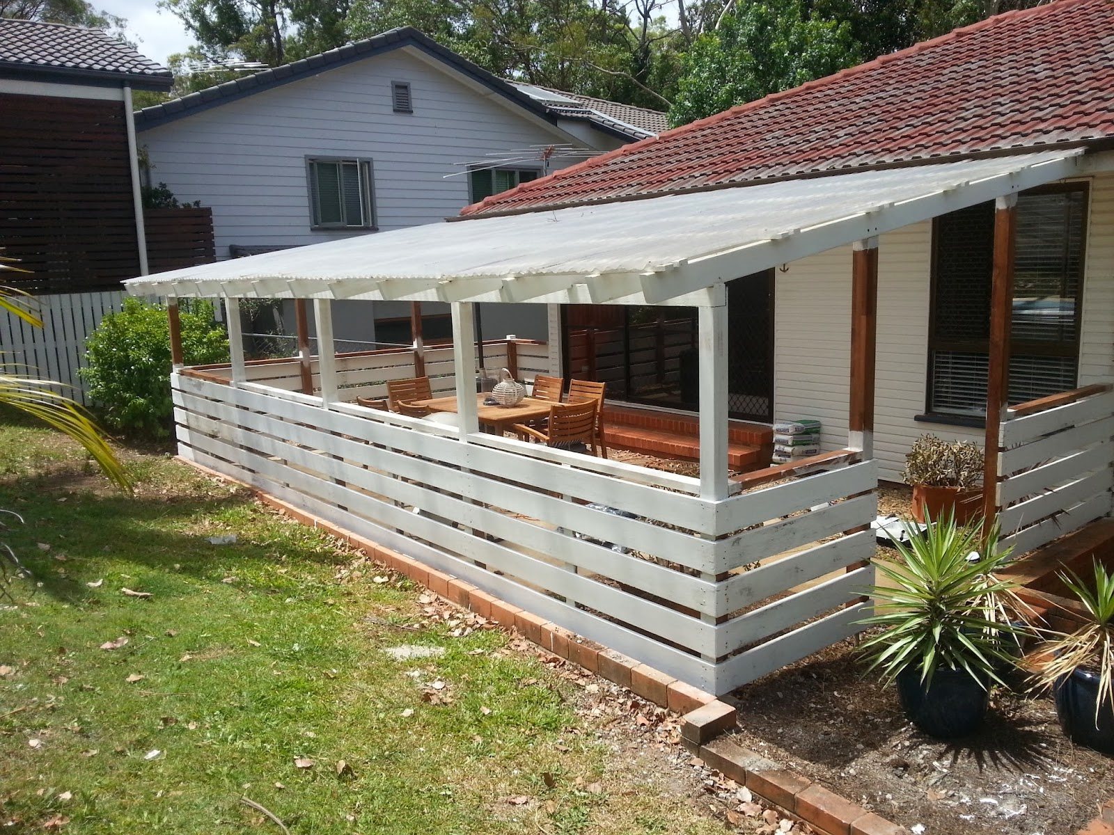 Timber deck with slatted privacy screen and pergola cover in a Brisbane backyard