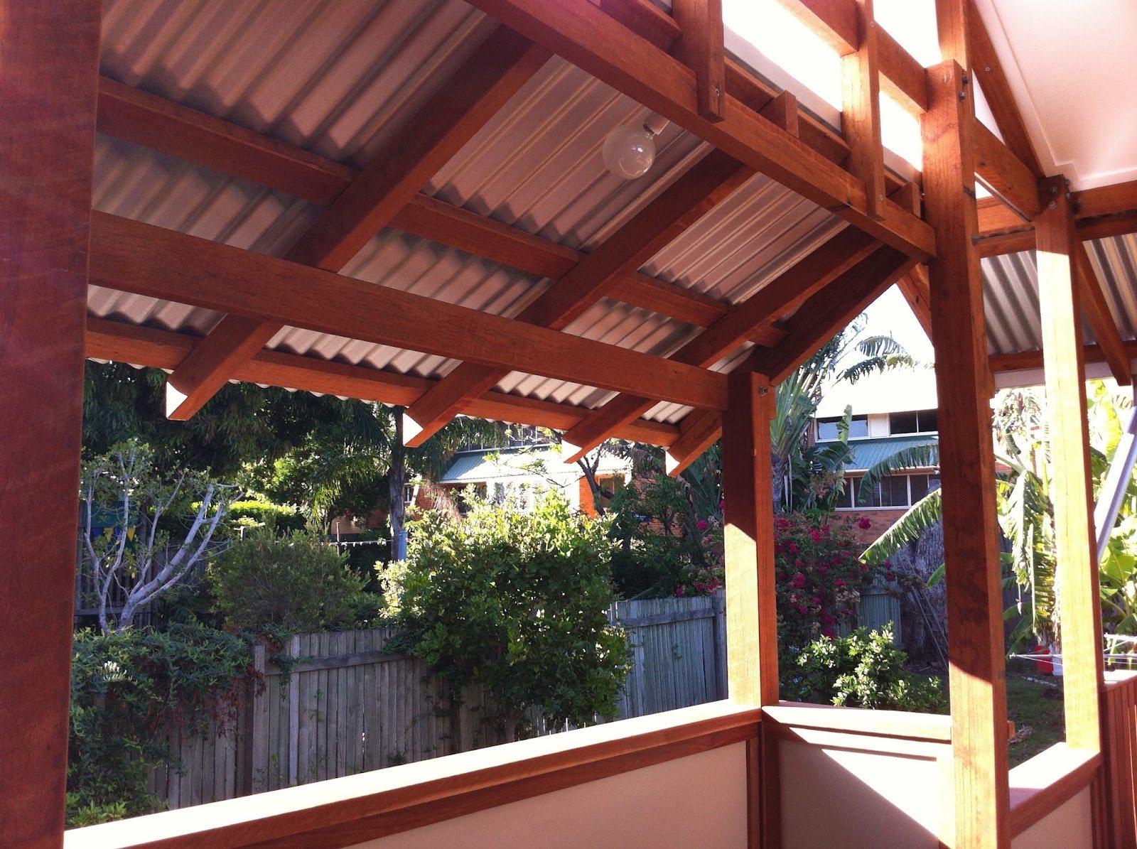 Exposed-timber pergola and patio roof framing built by Adam Pykett Carpentry