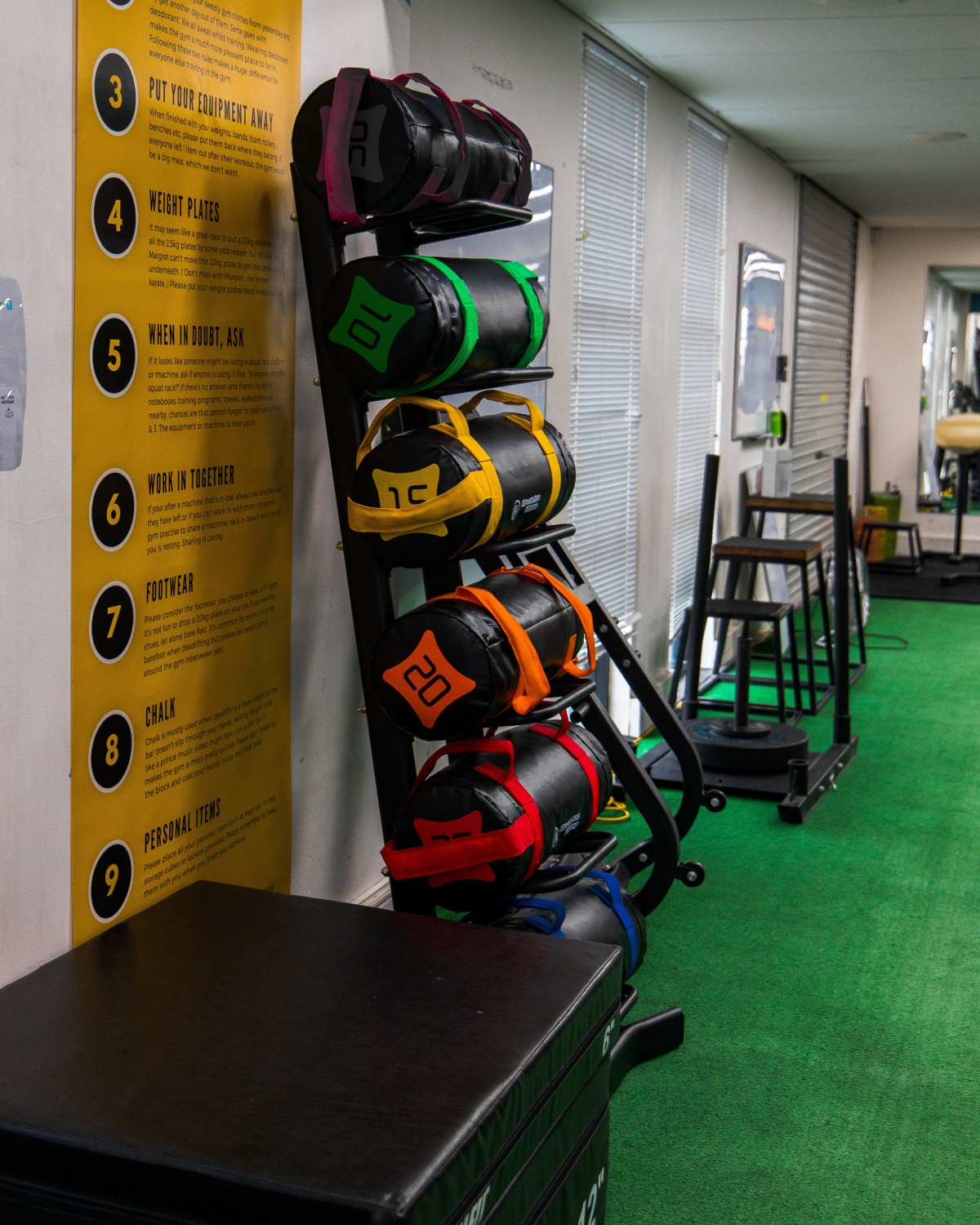 Sandbag rack with gym rules
