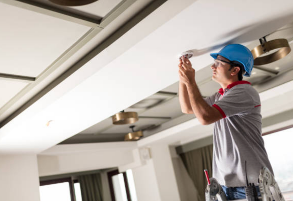 AMSCO electrician installing lighting indoors