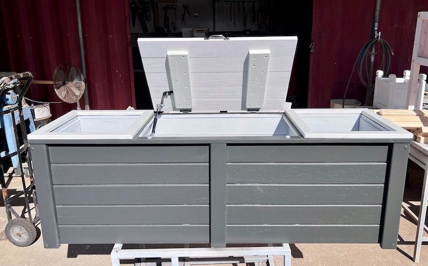 Timber outdoor kitchen unit with a white countertop and sink