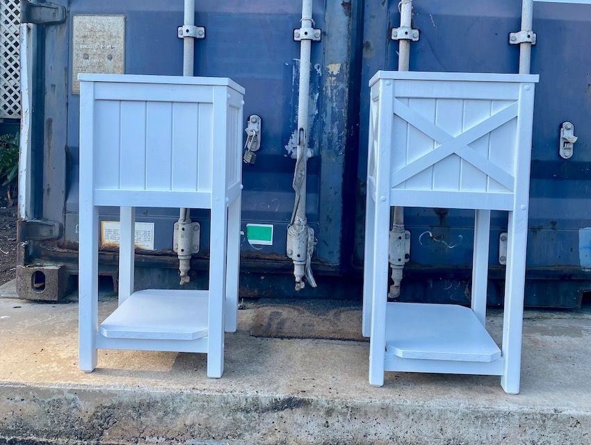 Two light-blue timber chairs against a wall