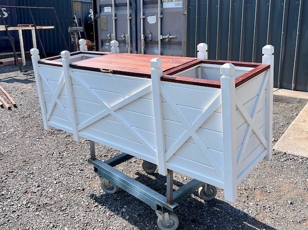 White utility cart on wheels with a timber top