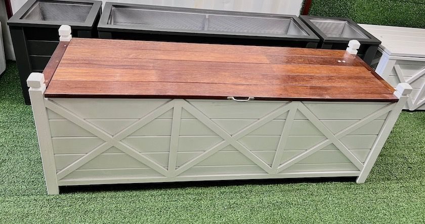 Outdoor planter bench with grey lattice sides and a timber lid