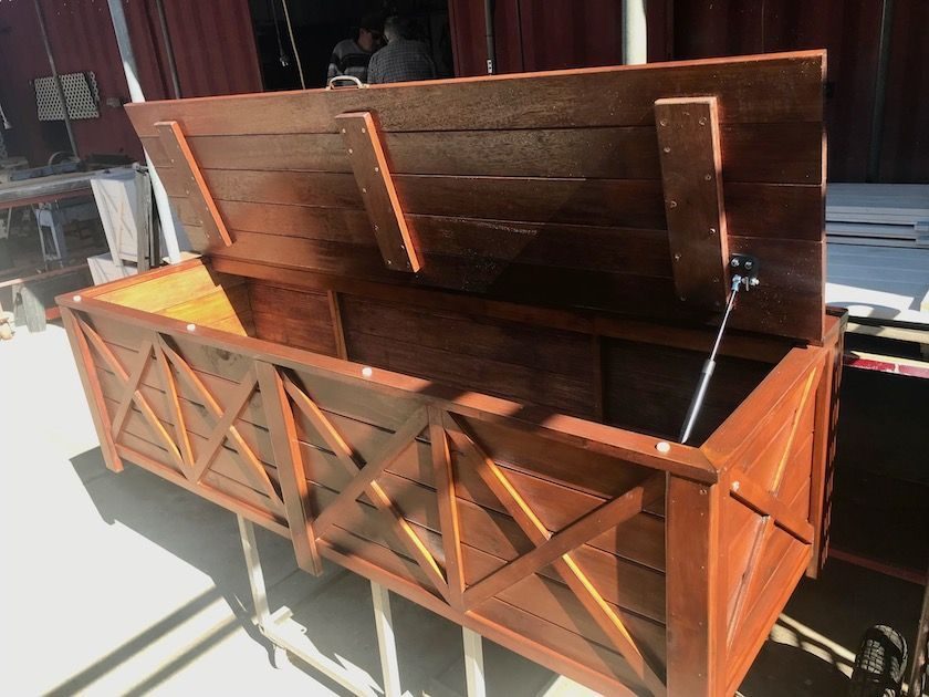 Timber storage chest with an open lid and crisscross front panels