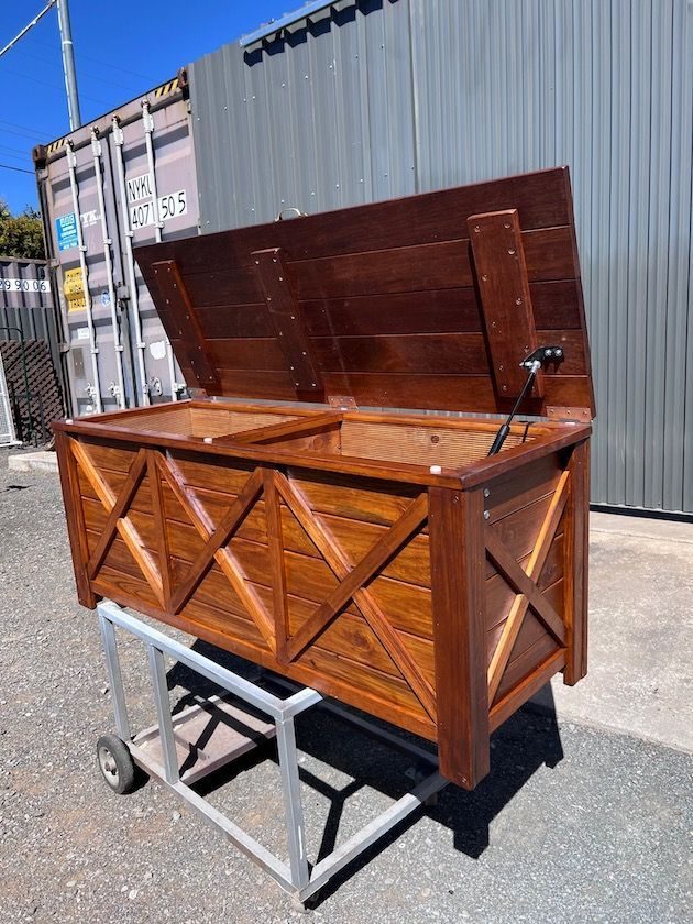 Timber storage chest on a metal stand with the lid open