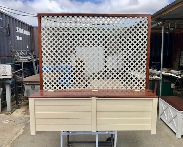 Outdoor cream display counter with a white lattice back panel