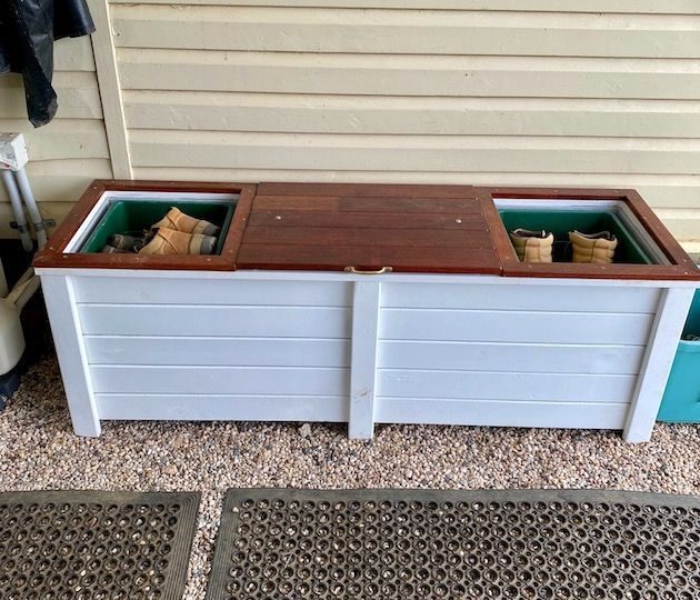 White planter bench with a brown top and two open storage compartments