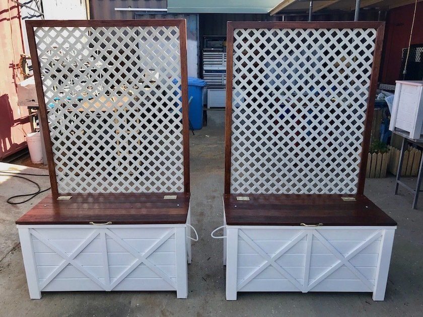 White lattice panels mounted on timber planter boxes outdoors