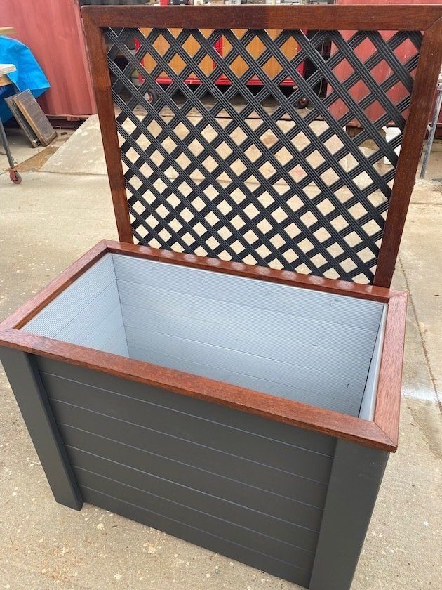 Open timber storage bench with black sides and a lattice backrest