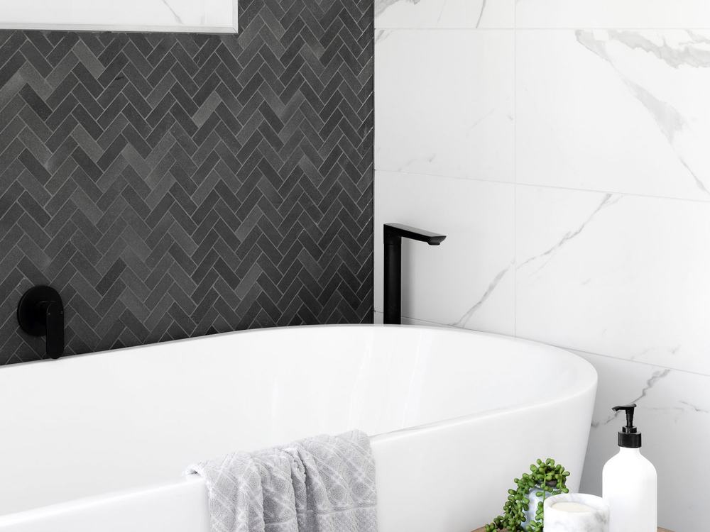 Charcoal herringbone feature wall and marble bathroom