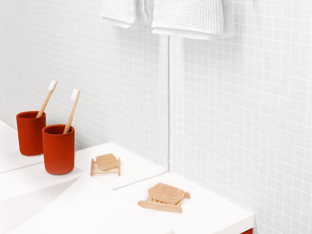 Crisp white-tiled bathroom with mosaic detail