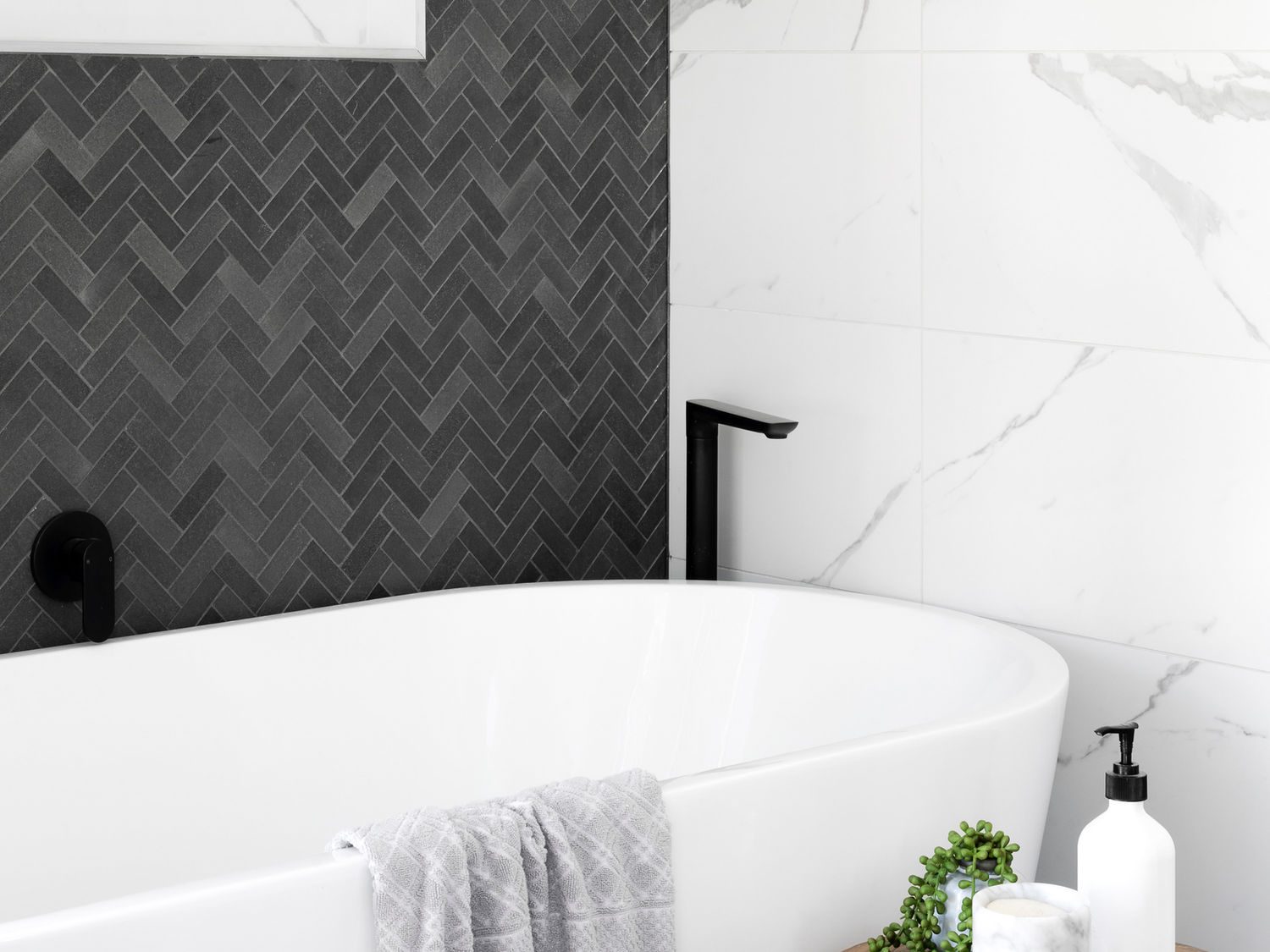 Charcoal herringbone feature wall and marble bathroom tiling by B Complete Tiling