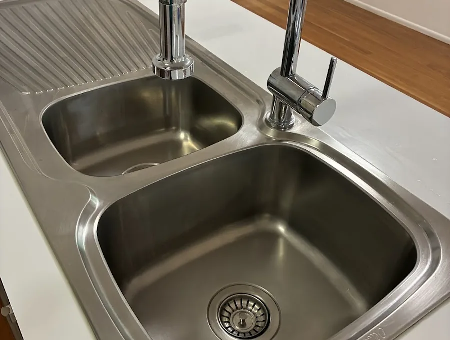 Spotless stainless steel kitchen sink after a deep clean by Bardon Clean