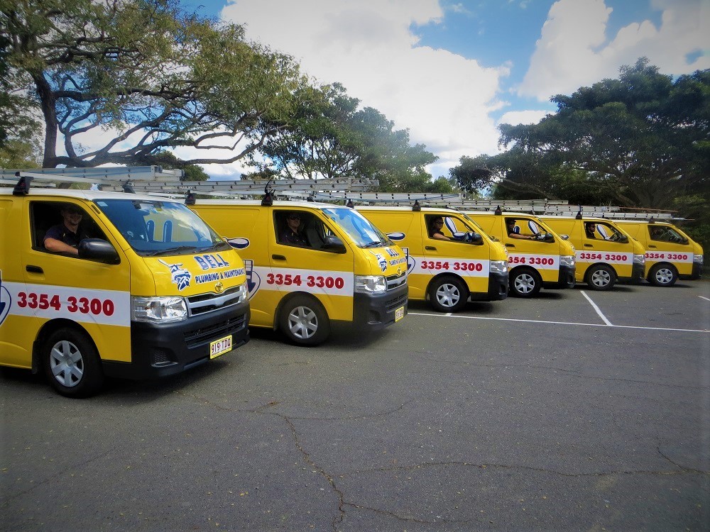 Bell Plumbing yellow service vans lined up in Brisbane