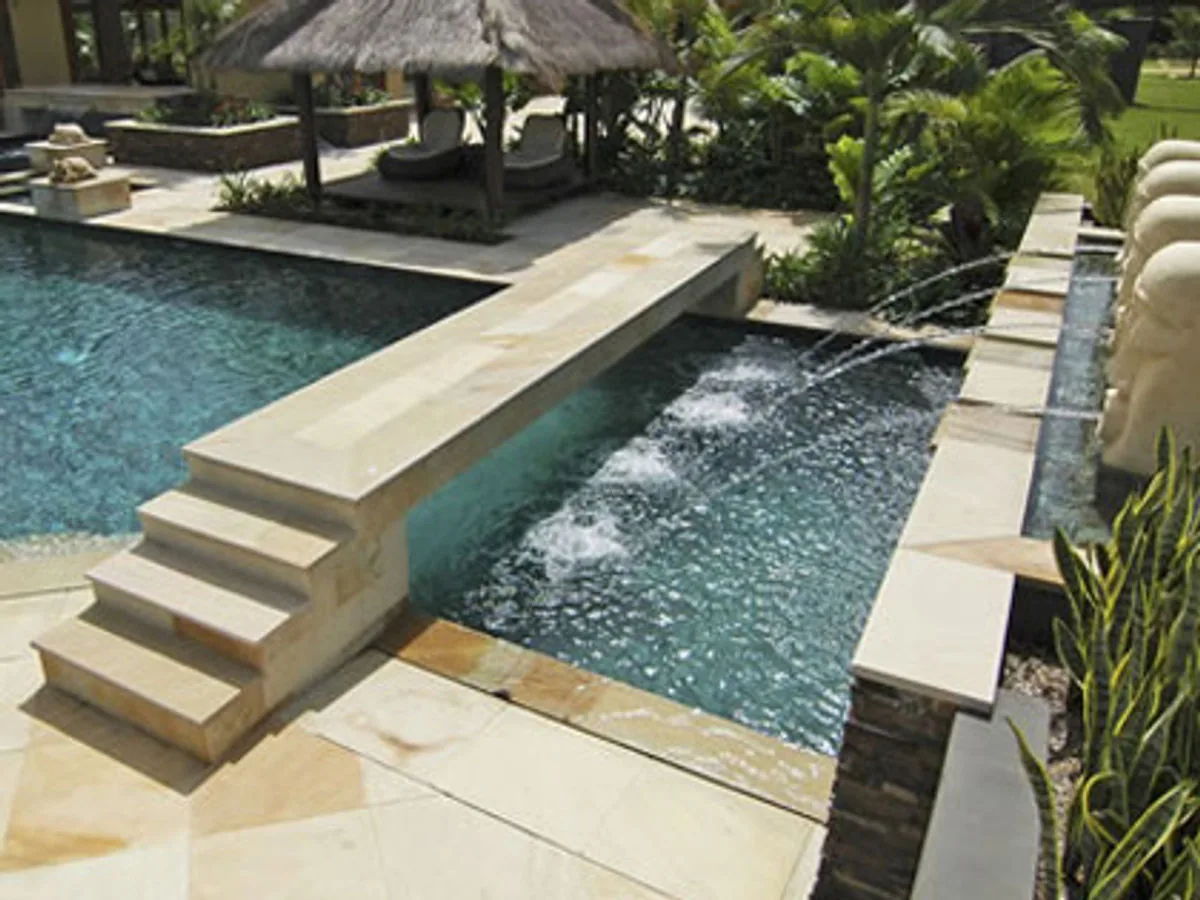 Luxury pool tiling and stone water feature