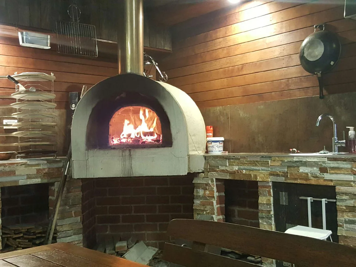 Stone-clad outdoor entertaining area with pizza oven