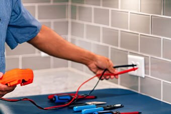 Electrician testing a power point in Bulimba