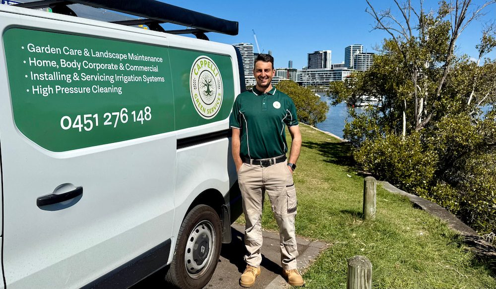 Andrea Cappelli, owner of Cappelli Green Services, beside his branded work van