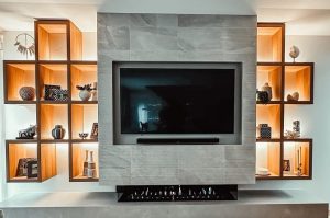 Hand laid large format wall tiles in grey colour in rumpus room surrounding a televisin
