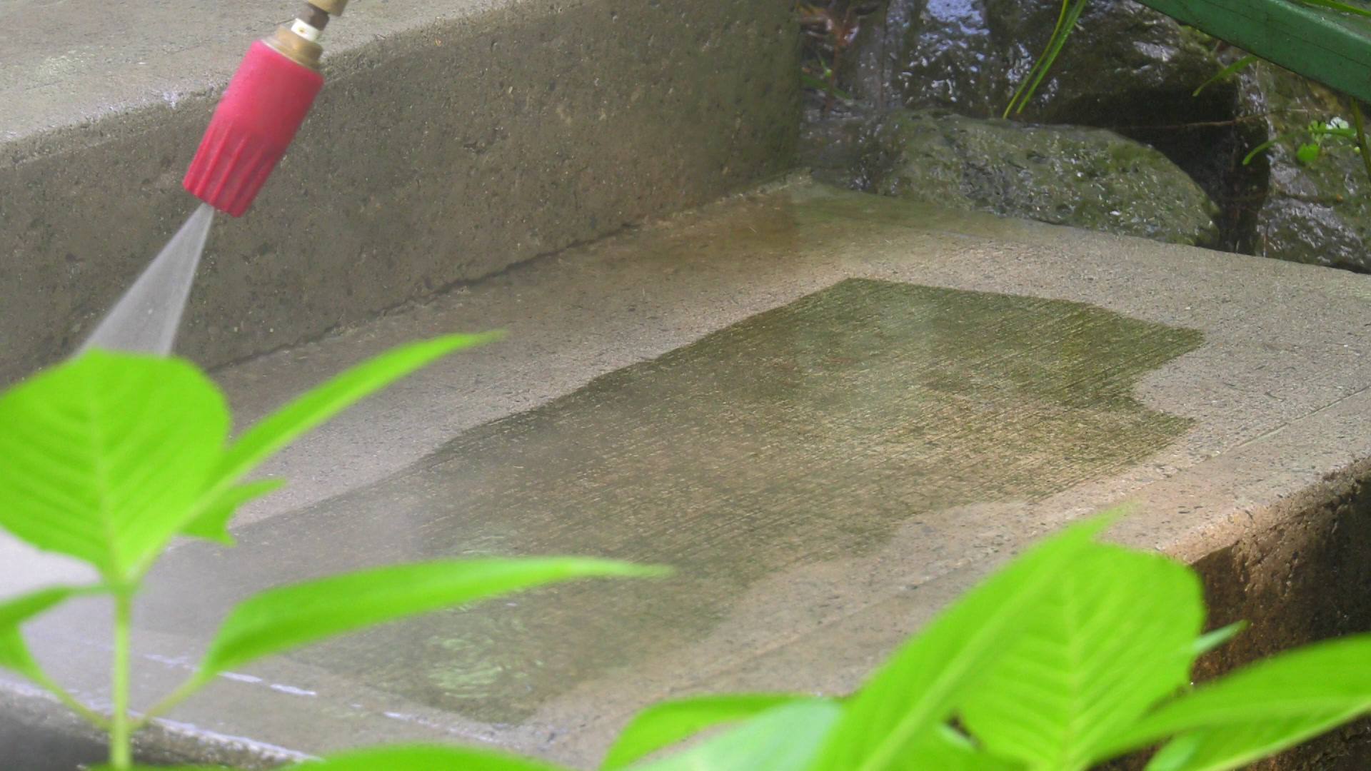 High-pressure cleaning a concrete surface