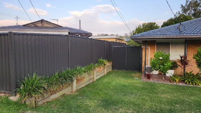 Colorbond fencing with timber garden bed borders