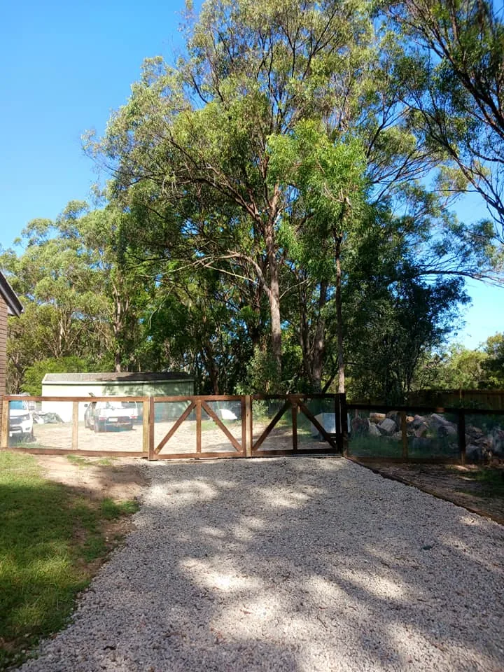 Timber entry gate and gravel driveway