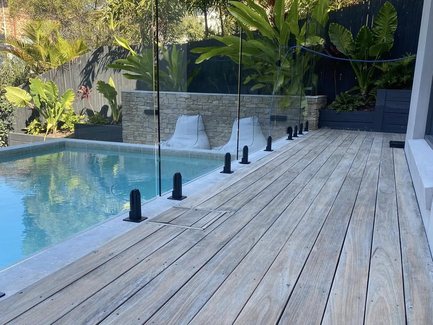 Poolside timber deck and landscaped garden