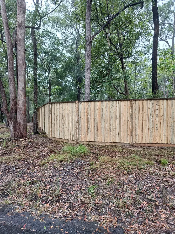 Timber fence line through bushland