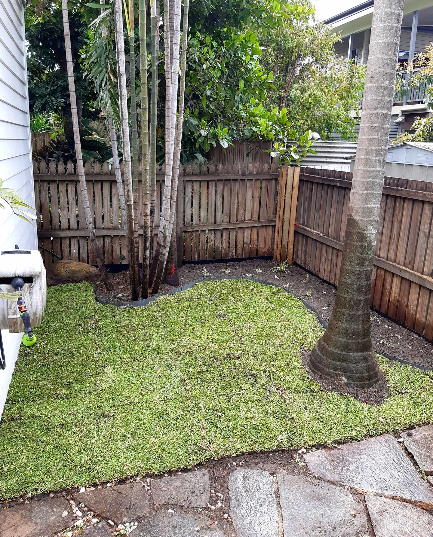 Freshly laid turf in a courtyard garden