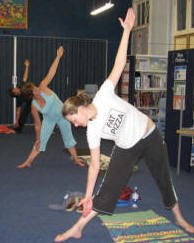 Students practicing triangle pose