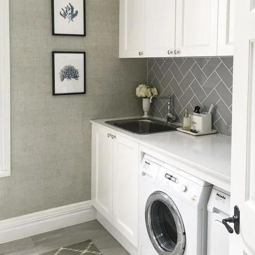 Renovated laundry with herringbone splashback