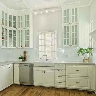 Renovated white country-style kitchen with timber floor