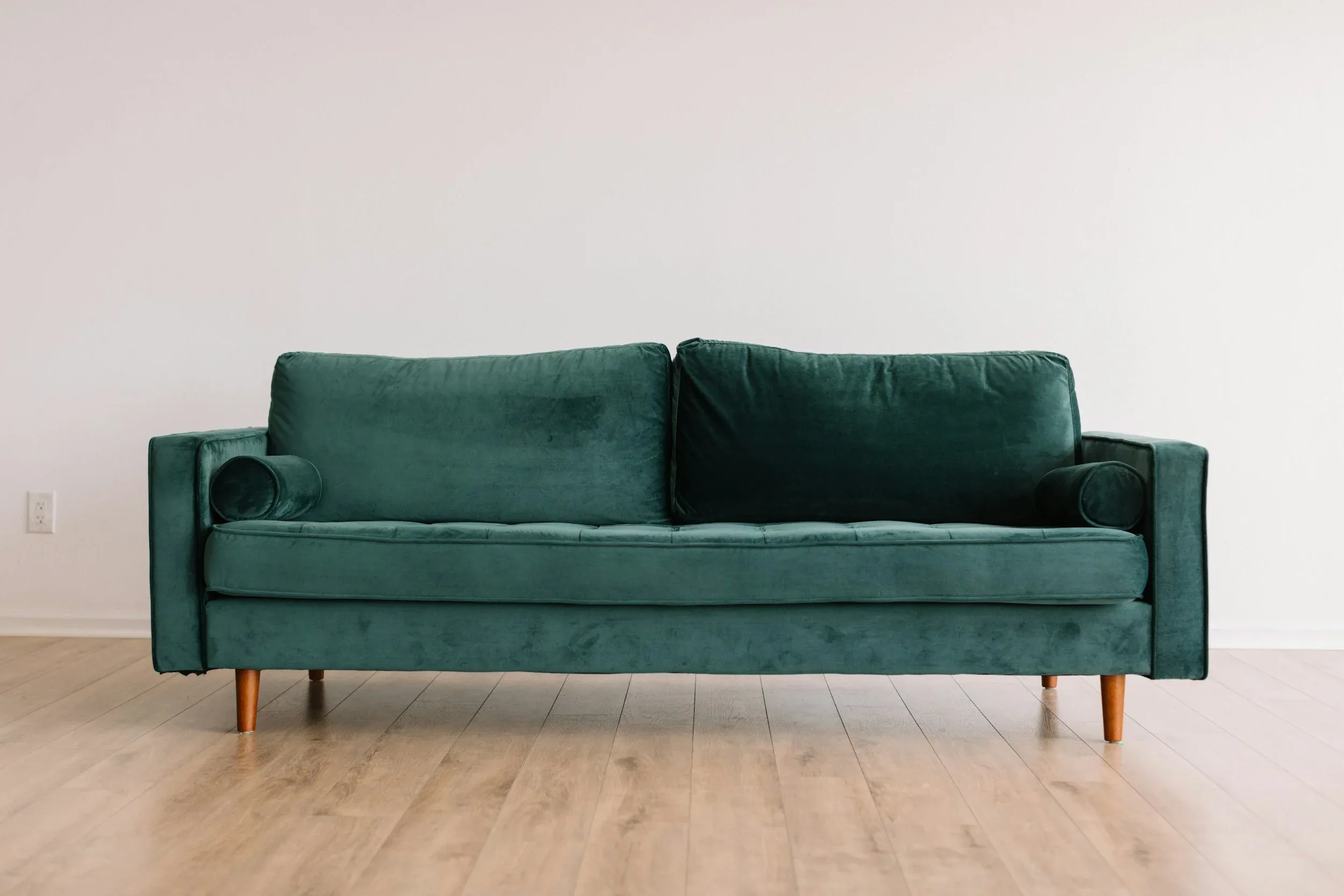 Green velvet couch for upholstery cleaning