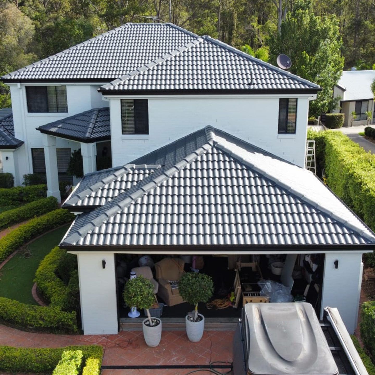 A Brisbane home with freshly painted walls and a restored charcoal roof by Mahy Painter