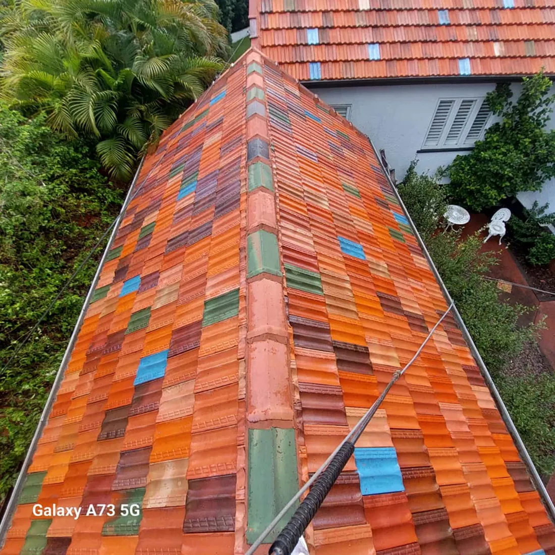 Terracotta tile roof cleaned by Mahy Painter