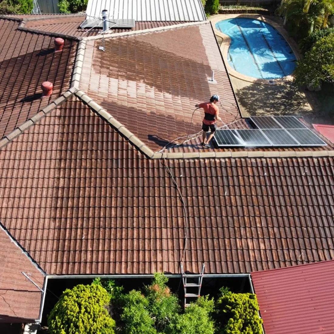 Mahy Painter cleaning a tile roof in Brisbane