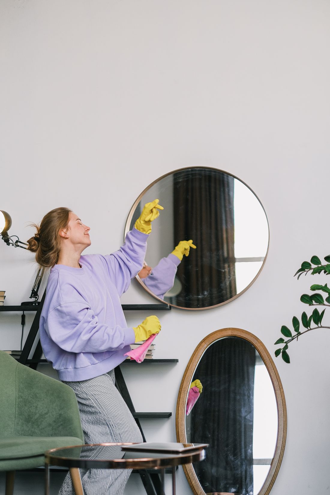 Cleaner polishing mirrors in a bright room