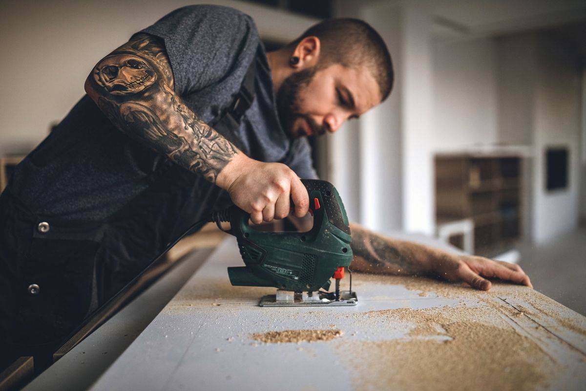 MJN Carpentry tradesman shaping timber on site