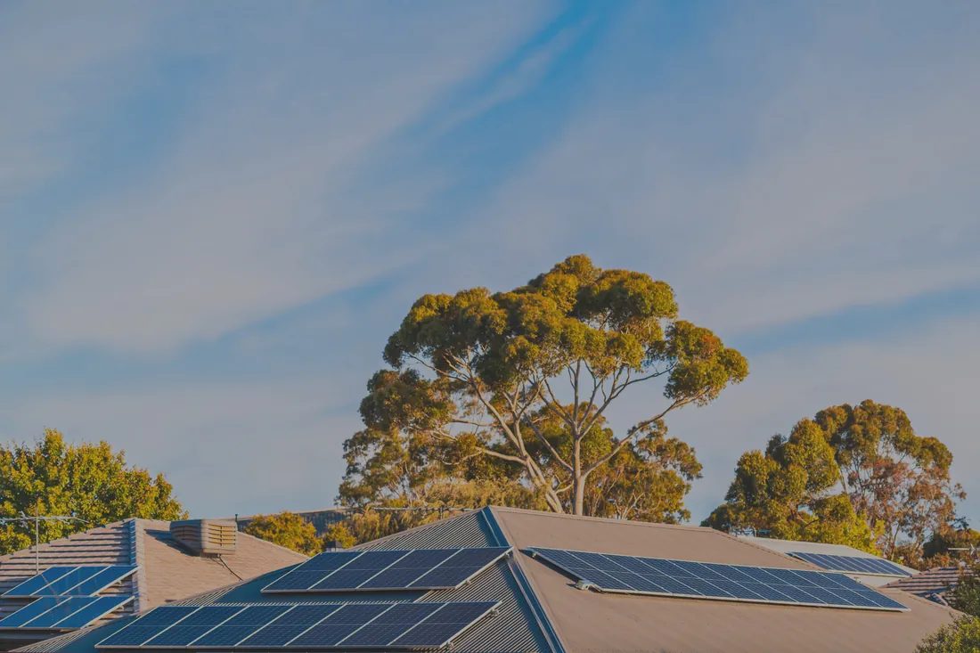 Rooftop solar panel array installed under clear blue Gold Coast sky