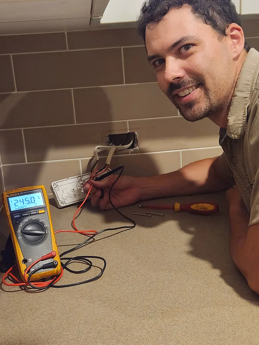 Electrician running and connecting new wiring during a home fit-out