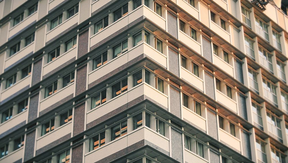 High-rise condominium building exterior in the Philippines with rows of balconies and windows