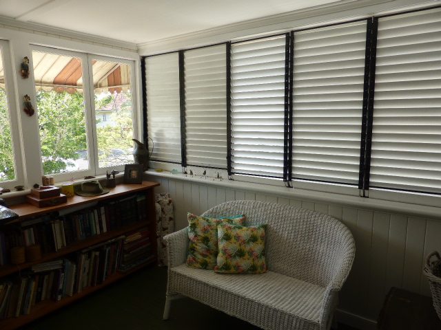 Enclosed sunroom with timber shutters