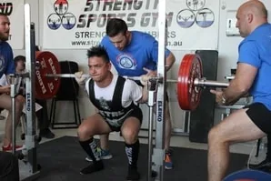 Peter Nguyen squatting at a powerlifting competition