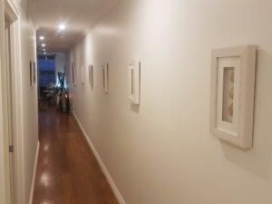 Hallway with timber floor and wall-mounted frames