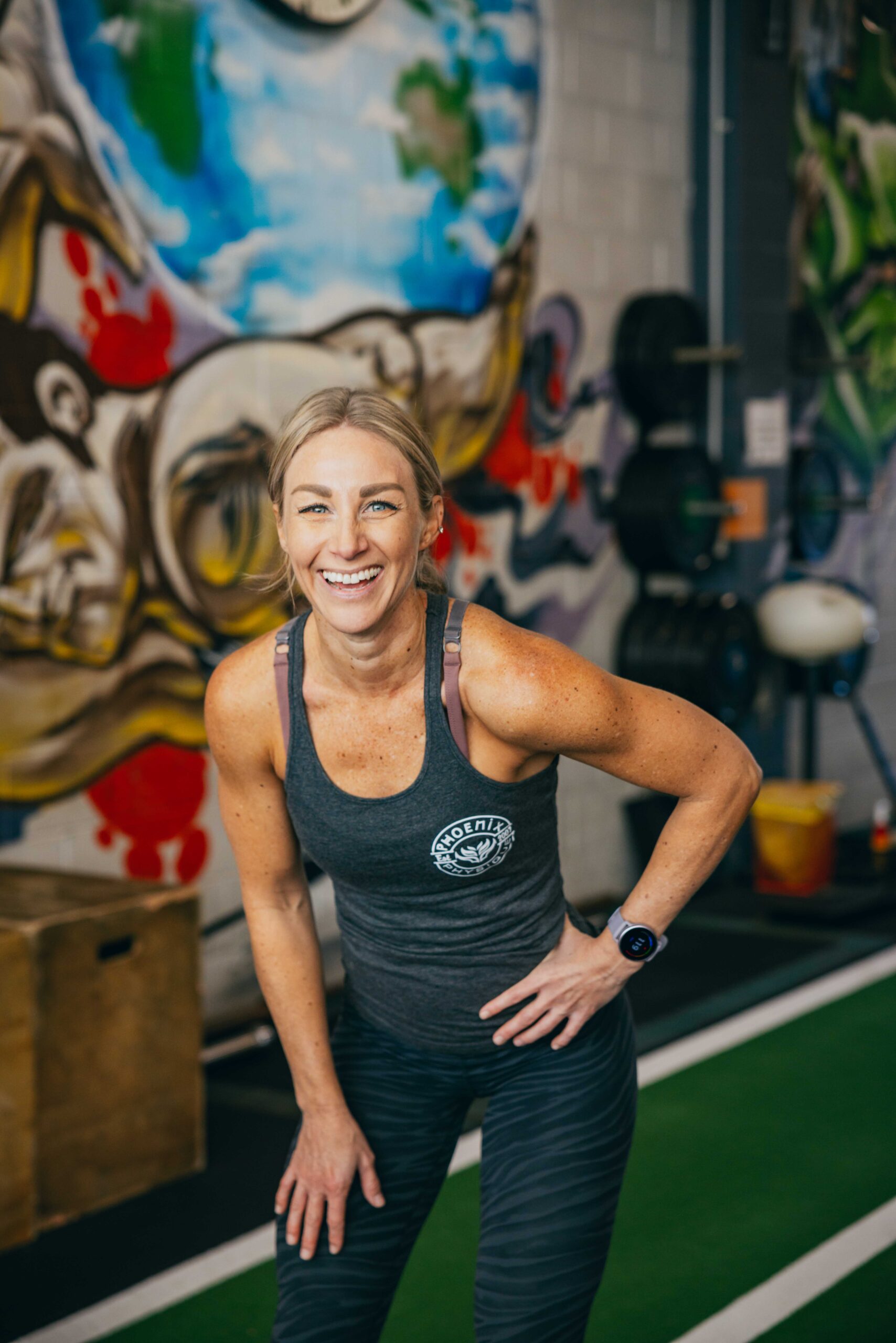 Phoenix Physique member smiling in branded singlet