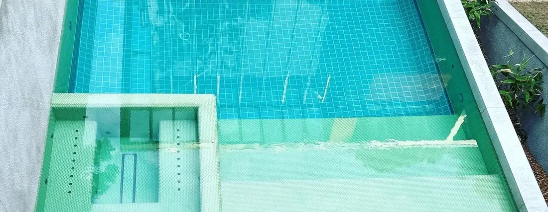 Tiled swimming pool with green mosaic finish