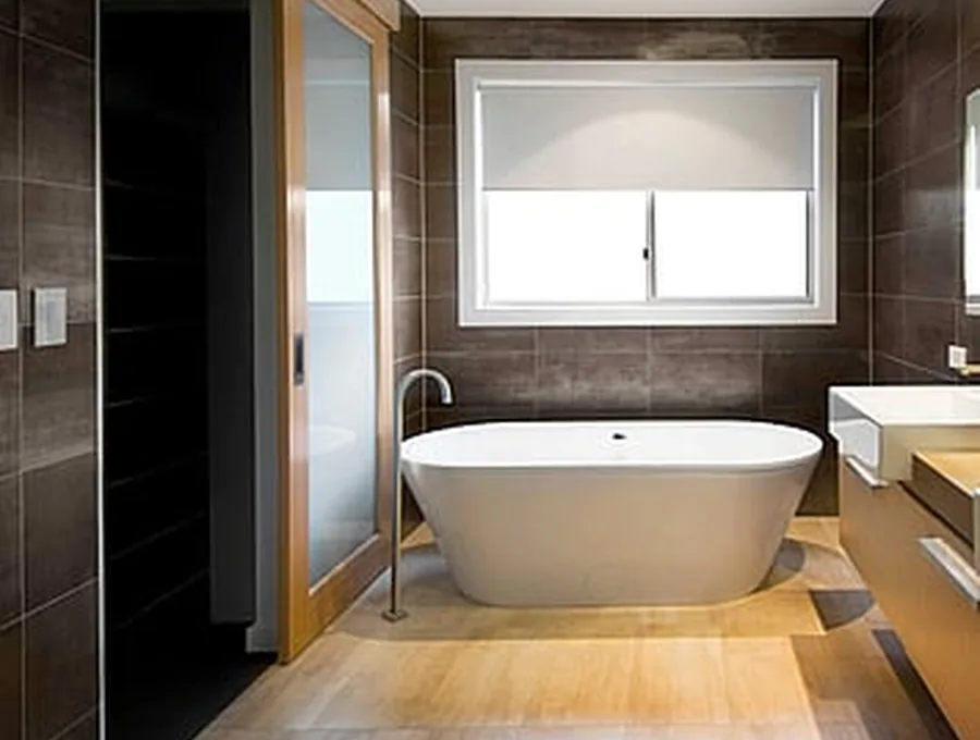 Twin-vanity bathroom with backlit mirrors and brushed brass tapware
