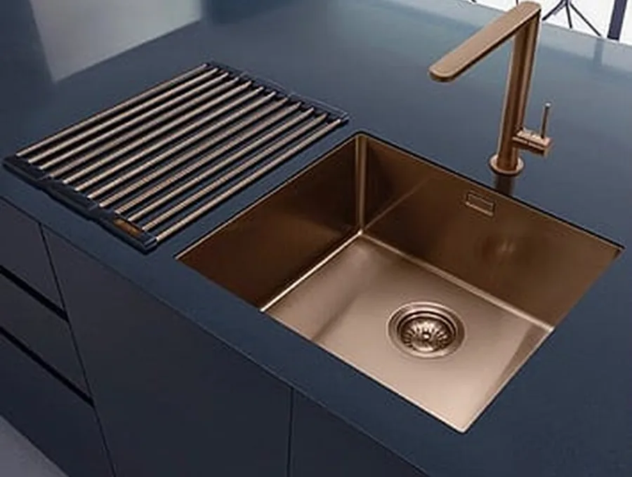 Copper undermount sink and matching tap in a navy kitchen benchtop