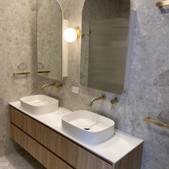Terrazzo-tiled bathroom with brass tapware